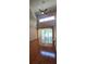 A bright living room featuring wood flooring, large windows, and an open floor plan at 42 Enclave Dr, Winter Haven, FL 33884