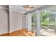 Living room with hardwood floors and open shutters to a screened in patio at 42 Enclave Dr, Winter Haven, FL 33884