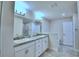 Elegant bathroom featuring a double sink vanity and separate tub & shower, perfect for a luxurious lifestyle at 4202 Teeling Ct, Auburndale, FL 33823