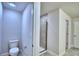 Contemporary bathroom with a toilet and tiled walk-in shower, designed for modern comfort and convenience at 4202 Teeling Ct, Auburndale, FL 33823