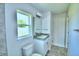 Quaint powder room with a sink and commode at 4202 Teeling Ct, Auburndale, FL 33823
