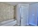 Bathroom with tiled shower and tub combo with modern fixtures at 4202 Teeling Ct, Auburndale, FL 33823