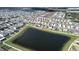 Aerial view of a neighborhood, including a pond in the background at 421 Chayne Pl, St Cloud, FL 34771