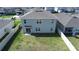 Aerial view of a fenced backyard, showing a lush green lawn, patio, and neighborhood surroundings at 421 Chayne Pl, St Cloud, FL 34771