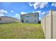 Large, fenced-in backyard with a grassy lawn, perfect for outdoor activities and entertaining at 421 Chayne Pl, St Cloud, FL 34771
