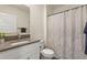 Bright bathroom featuring neutral vanity with white cabinets and a shower with patterned curtain at 421 Chayne Pl, St Cloud, FL 34771