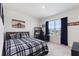 Comfortable bedroom featuring a bed, window with blinds, and desk area for work or hobbies at 421 Chayne Pl, St Cloud, FL 34771