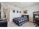 Comfortable bedroom featuring a bed, window with blinds, and desk area for work or hobbies at 421 Chayne Pl, St Cloud, FL 34771