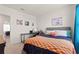 Cozy bedroom features a desk, comfortable bed, and colorful decor at 421 Chayne Pl, St Cloud, FL 34771