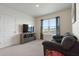 Bright bonus room features a comfortable couch, storage, and a beautiful exterior view at 421 Chayne Pl, St Cloud, FL 34771