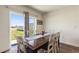 Cozy dining area with a wooden table, white chairs, and natural light from sliding glass doors at 421 Chayne Pl, St Cloud, FL 34771