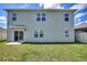 Home exterior featuring a well-kept lawn, sliding glass doors, and several windows for natural light at 421 Chayne Pl, St Cloud, FL 34771