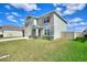 Two-story home featuring stone accents, a two-car garage, and a well-manicured lawn at 421 Chayne Pl, St Cloud, FL 34771