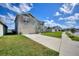 Two-story home with stone accents, two-car garage, well-manicured lawn, and neutral colored facade at 421 Chayne Pl, St Cloud, FL 34771