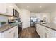 Stylish kitchen featuring stainless steel appliances, white cabinets, and spacious layout at 421 Chayne Pl, St Cloud, FL 34771