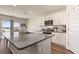 Modern kitchen boasts stainless steel appliances, white cabinetry, and spacious island at 421 Chayne Pl, St Cloud, FL 34771