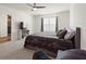Tranquil main bedroom showcases large windows, plush carpeting, and a cozy seating area at 421 Chayne Pl, St Cloud, FL 34771
