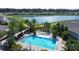 Community pool with lounge chairs, set against a serene pond and neighborhood backdrop at 421 Chayne Pl, St Cloud, FL 34771