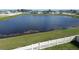 A large body of water with a fence in the foreground at 421 Chayne Pl, St Cloud, FL 34771