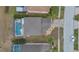 Aerial view of a house with screened-in pool and backyard at 435 Gleneagles Dr, Davenport, FL 33897