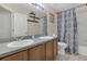 Well-lit bathroom featuring a double sink vanity, neutral tiles and a shower with tub at 435 Gleneagles Dr, Davenport, FL 33897