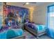 Charming bedroom with Frozen themed decor and twin beds, complemented by a ceiling fan at 435 Gleneagles Dr, Davenport, FL 33897