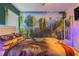 Enchanting Avatar-themed bedroom featuring a king bed, scenic mural, and soft, ambient lighting at 435 Gleneagles Dr, Davenport, FL 33897