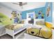 Cheerful Minions-themed bedroom with two beds, bright blue walls, and sunny yellow accents at 435 Gleneagles Dr, Davenport, FL 33897