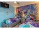Cozy bedroom with Frozen themed decor and twin beds, accented by a ceiling fan at 435 Gleneagles Dr, Davenport, FL 33897