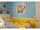 Brightly decorated bedroom with Minions themed decor and bedding creates a fun atmosphere at 435 Gleneagles Dr, Davenport, FL 33897