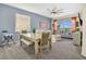 Open-concept dining and living area with gray walls, natural light, and modern furnishings at 435 Gleneagles Dr, Davenport, FL 33897
