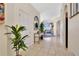 Inviting entryway featuring neutral tile, arched doorways, modern table decor, and an open view to the living area at 435 Gleneagles Dr, Davenport, FL 33897