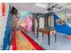 Fun game room with a shuffleboard table, foosball, and vibrant Marvel-themed wall decor at 435 Gleneagles Dr, Davenport, FL 33897