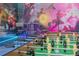 Fantastic game room, complete with foosball table, wall art, and bar seating at 435 Gleneagles Dr, Davenport, FL 33897