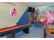 Spacious game room featuring shuffleboard, foosball table, and Marvel-themed decor at 435 Gleneagles Dr, Davenport, FL 33897