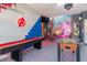 Spacious game room featuring a shuffleboard table, foosball, and an Avengers-themed mural for Gathering fun at 435 Gleneagles Dr, Davenport, FL 33897