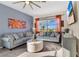 Comfortable living room with natural light, stylish sofas, modern decor, and a view of the screened-in lanai at 435 Gleneagles Dr, Davenport, FL 33897