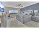 Serene main bedroom featuring a large window, neutral colors and contemporary furnishings at 435 Gleneagles Dr, Davenport, FL 33897