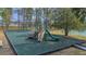 Community playground with updated equipment, a soft rubber surface and mature trees, perfect for recreation at 435 Gleneagles Dr, Davenport, FL 33897