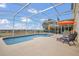 Enclosed screened-in pool with patio furniture, lounge chairs, and exterior view at 435 Gleneagles Dr, Davenport, FL 33897