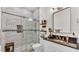 Modern bathroom featuring glass shower with decorative tile, vanity with granite counter and modern fixtures at 5345 Bloomfield Blvd, Lakeland, FL 33810