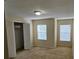 Bright bedroom with closet and two windows, offering ample storage and natural light at 5407 Quarry Rock Rd, Lakeland, FL 33809