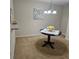 A quaint dining area showcases a round wood table, chandelier, and neutral carpet flooring at 5407 Quarry Rock Rd, Lakeland, FL 33809