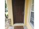 Inviting front door with decorative brick accents and a welcoming mat at 5407 Quarry Rock Rd, Lakeland, FL 33809