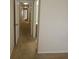 Hallway with carpet and access to doors and rooms, connecting the various spaces of the home at 5407 Quarry Rock Rd, Lakeland, FL 33809