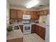 Efficient kitchen with ample cabinet space, essential appliances, and easy-to-clean tile floors for convenience at 5407 Quarry Rock Rd, Lakeland, FL 33809