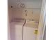 Laundry room with white washer and dryer and shelving at 5407 Quarry Rock Rd, Lakeland, FL 33809