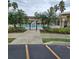 Gated community pool surrounded by palm trees, foliage, and black metal fencing at 5407 Quarry Rock Rd, Lakeland, FL 33809