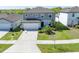 Stunning aerial view of a two-story home showcasing its well-manicured lawn, landscaping, and spacious driveway at 5531 Keaton Springs Dr, Lakeland, FL 33811