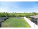 A Large private fenced backyard featuring a green lawn and a wooded area at 5531 Keaton Springs Dr, Lakeland, FL 33811
